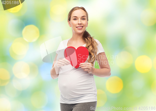 Image of happy pregnant woman with red heart