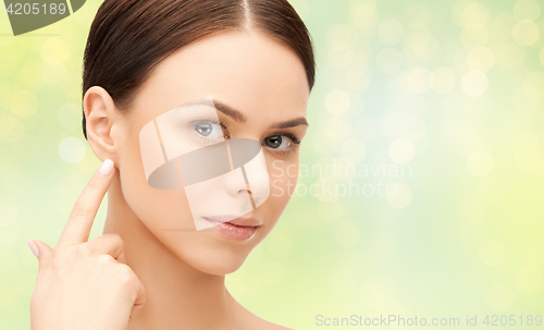 Image of close up of beautiful young woman face over green