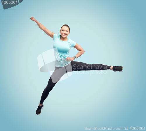 Image of happy smiling sporty young woman jumping in air