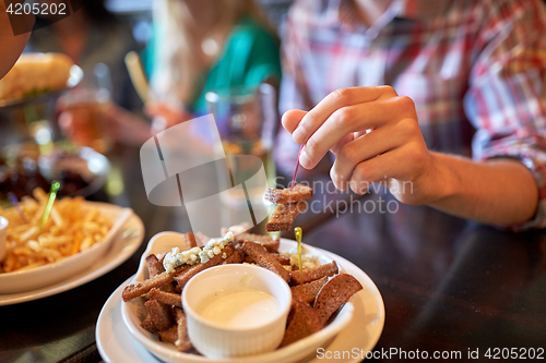 Image of happy man drinking beer at bar or pub