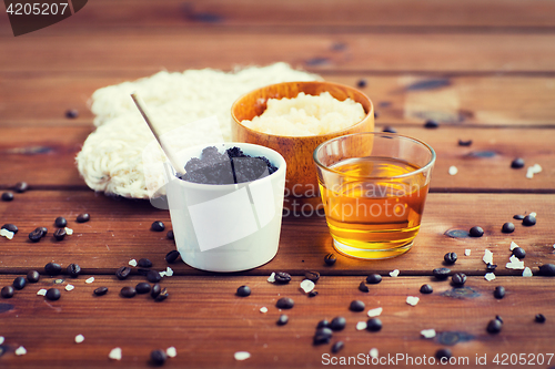 Image of close up of coffee scrub in cup and honey on wood