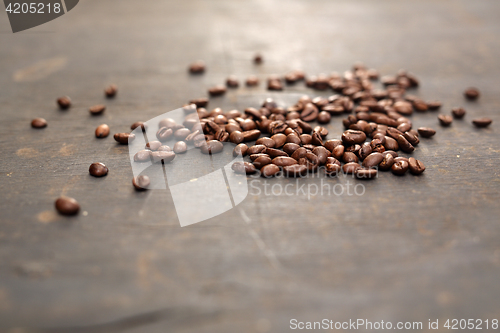 Image of Coffee beans scattered on a black board