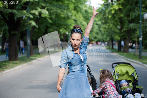 Image of mother with her daughters in the park