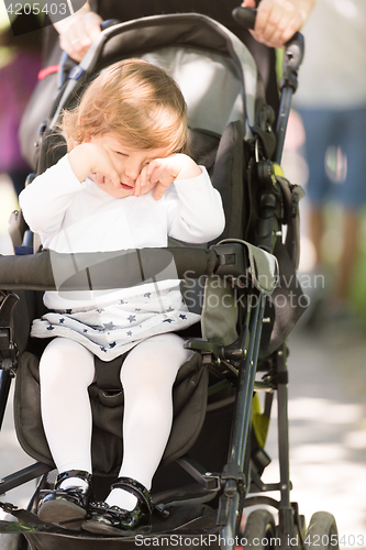 Image of baby girl sitting in the pram