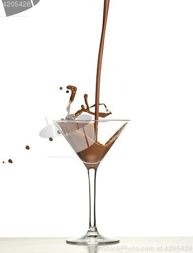 Image of macro shoot with hot chocolate falling in glass on white in studio