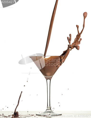 Image of macro shoot with hot chocolate falling in glass on white in studio