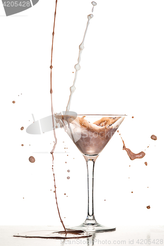 Image of macro shoot with hot chocolate falling in glass on white in studio