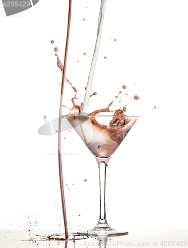 Image of macro shoot with hot chocolate falling in glass on white in studio