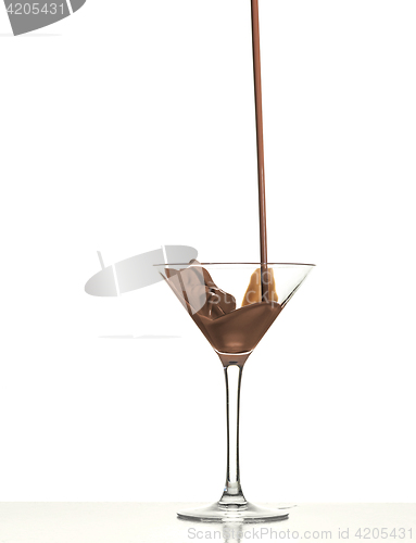 Image of macro shoot with hot chocolate falling in glass on white in studio