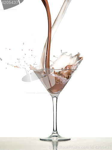 Image of macro shoot with hot chocolate falling in glass on white in studio