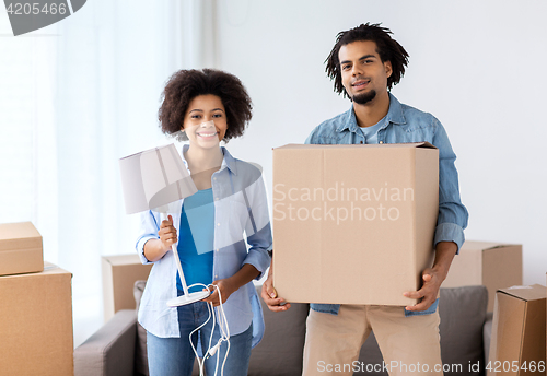 Image of happy couple with stuff moving to new home