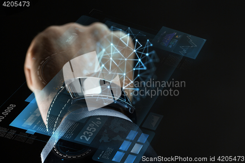 Image of close up of businessman hand with smartwatch