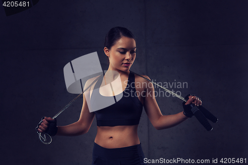 Image of young sporty woman with jumping rope
