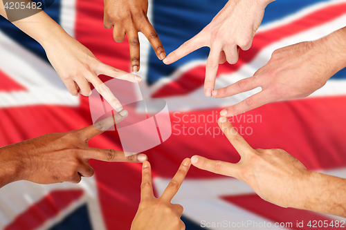 Image of group of international people showing peace sign