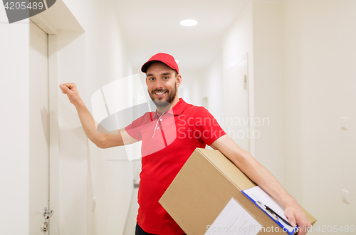 Image of delivery man with parcel box knocking on door