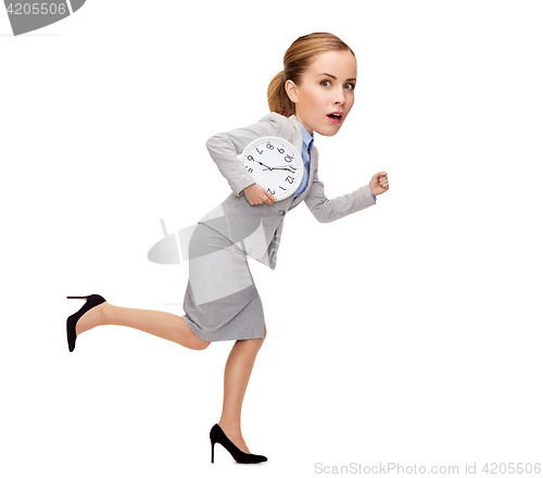 Image of stressed young businesswoman with clock running