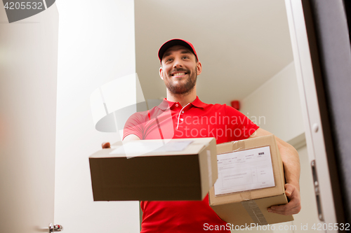 Image of delivery man with parcel boxes at customer door