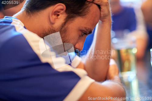 Image of close up of sad football fan at bar or pub