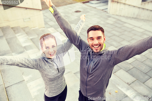 Image of happy smiling couple outdoors on city street