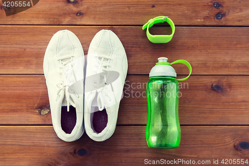 Image of close up of sneakers, bracelet and water bottle