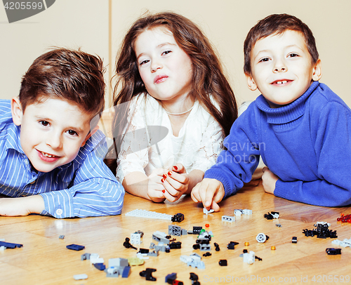 Image of funny cute children playing toys at home, boys and girl smiling, first education role lifestyle 