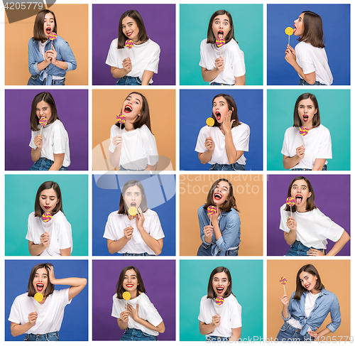 Image of young woman with the colorful lollipop at studio