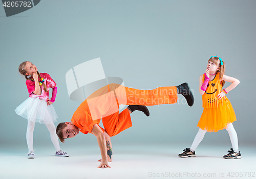 Image of Group of man, woman and teens dancing hip hop choreography