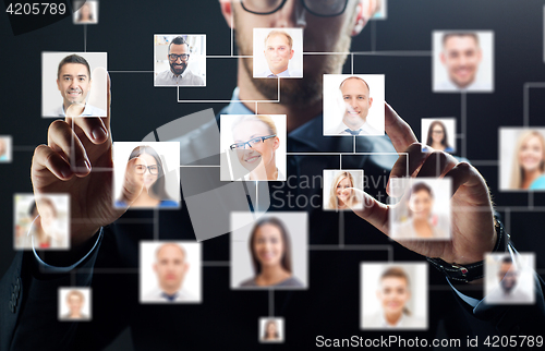 Image of close up of businessman with virtual contact icons