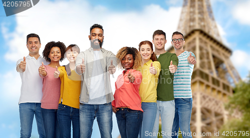 Image of  people showing thumbs up over eiffel tower