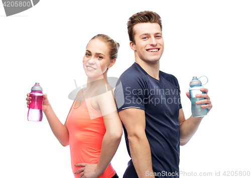 Image of sportive man and woman with water bottles