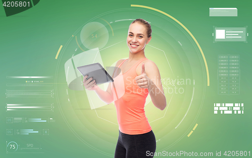 Image of happy smiling sportive young woman with tablet pc