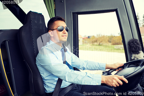 Image of happy driver driving intercity bus