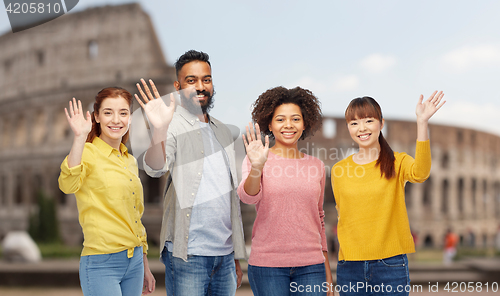 Image of international group of happy people waving hands