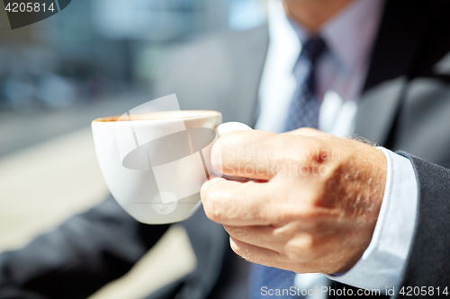 Image of senior businessman hand with coffee cup outdoors