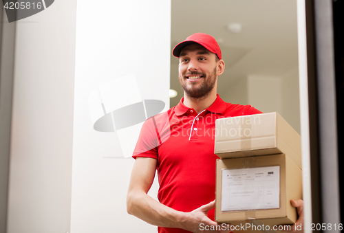 Image of delivery man with parcel boxes at customer door