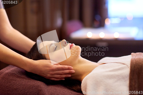 Image of woman having face and head massage at spa