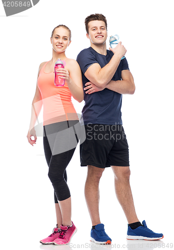 Image of sportive man and woman with water bottles