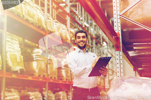 Image of businessman with clipboard at warehouse