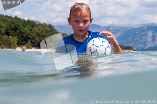 Image of Boy with UV protection shirt in a lake