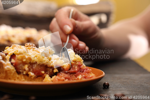 Image of Homemade cake with fruit. Tart on flaky pastry with plums and powdered sugar