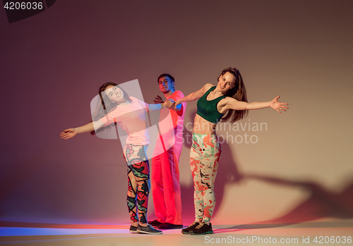 Image of Group of man, woman and teens dancing hip hop choreography