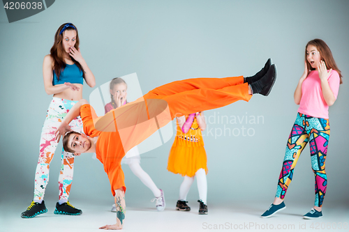 Image of Group of man, woman and teens dancing hip hop choreography