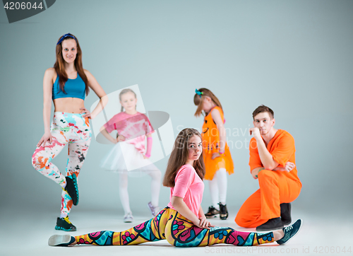 Image of Group of man, woman and teens dancing hip hop choreography