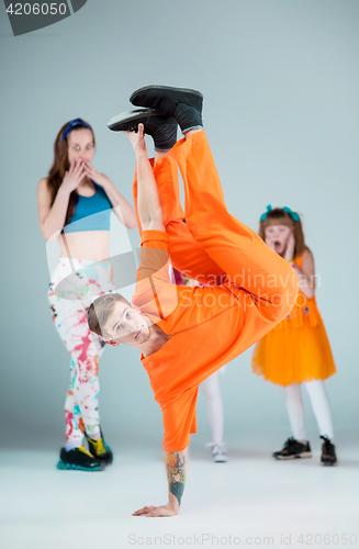 Image of Group of man, woman and teens dancing hip hop choreography