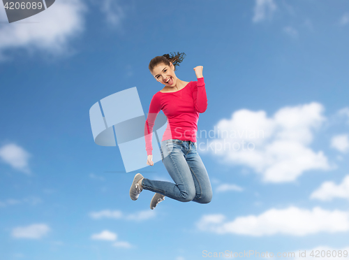 Image of smiling young woman jumping in air