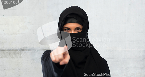 Image of muslim woman in hijab pointing finger to you