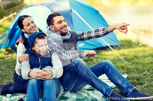 Image of happy family with tent at camp site