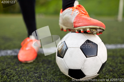 Image of soccer player playing with ball on football field