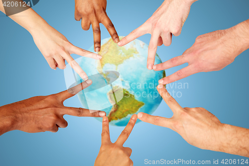 Image of group of international people showing peace sign