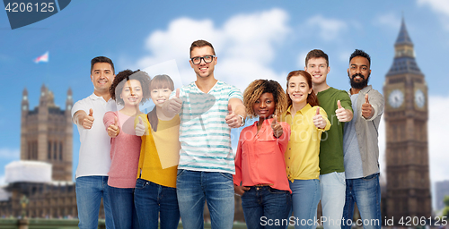 Image of happy people showing thumbs up over london